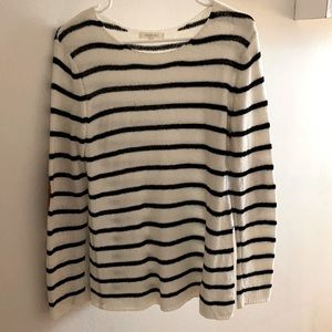White and black sweater with elbow detailing.